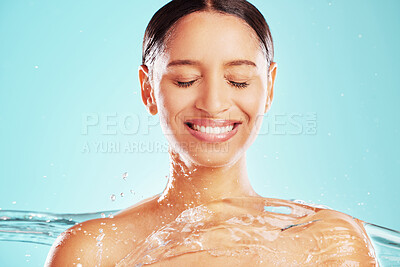 Buy stock photo Shot of an attractive young woman showering against a blue background