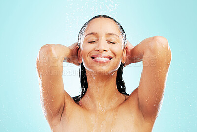 Buy stock photo Shot of an attractive young woman showering against a blue background