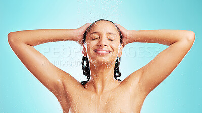 Buy stock photo Shot of an attractive young woman showering against a blue background