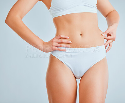 Buy stock photo Cropped shot of an unrecognizable woman pulling the skin on her waist