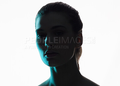 Buy stock photo Silhouette, portrait and woman in neon shadow with dark lighting or posing in studio in futuristic glow and isolated in studio. Aesthetic, creativity and face model in blue color design on background