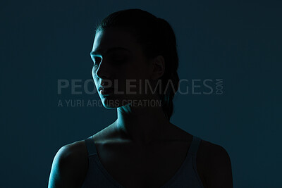 Buy stock photo Mystery, beauty and woman in shadow for secret with skincare, cosmetics or creative aesthetic with space. Art deco, person and model with natural face and light on skin with dark background in studio