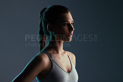 Buy stock photo Serious, fitness and woman with thinking in studio for exercise, healthy body and wellness. Light, person and female athlete with idea for self care, workout and sports training on black background