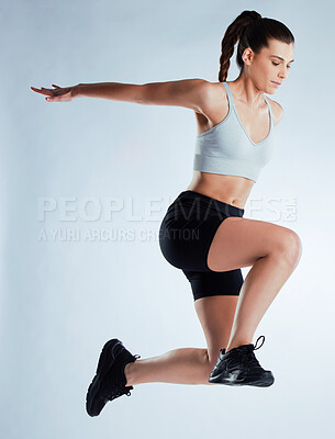 Buy stock photo Woman, fitness and jumping workout in studio for wellness with exercise, running and strong body. Moving, sports and athlete girl in air for health, training performance and power by white background