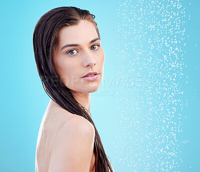 Buy stock photo Portrait of a beautiful young woman enjoying a refreshing shower against a blue background