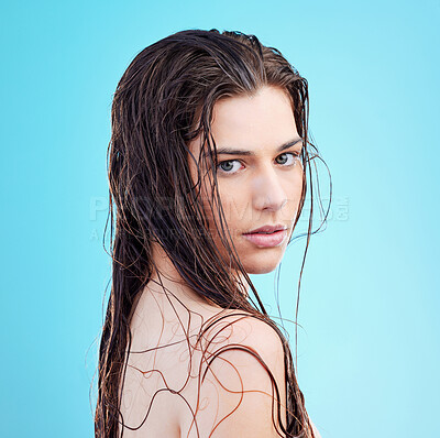 Buy stock photo Portrait of a beautiful young woman enjoying a refreshing shower against a blue background