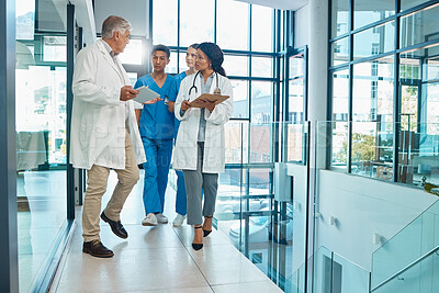 Buy stock photo Medical team, doctors and nurses walking together discussion, planning or strategy. Diversity men and women group talking about communication strategy, virus or surgery schedule in a hospital