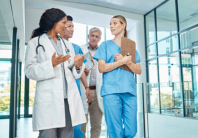 Buy stock photo Walking, doctors and nurses talking in a hospital for planning, strategy or results. Diversity men and women healthcare group together for discussion, virus or surgery with professional medical team