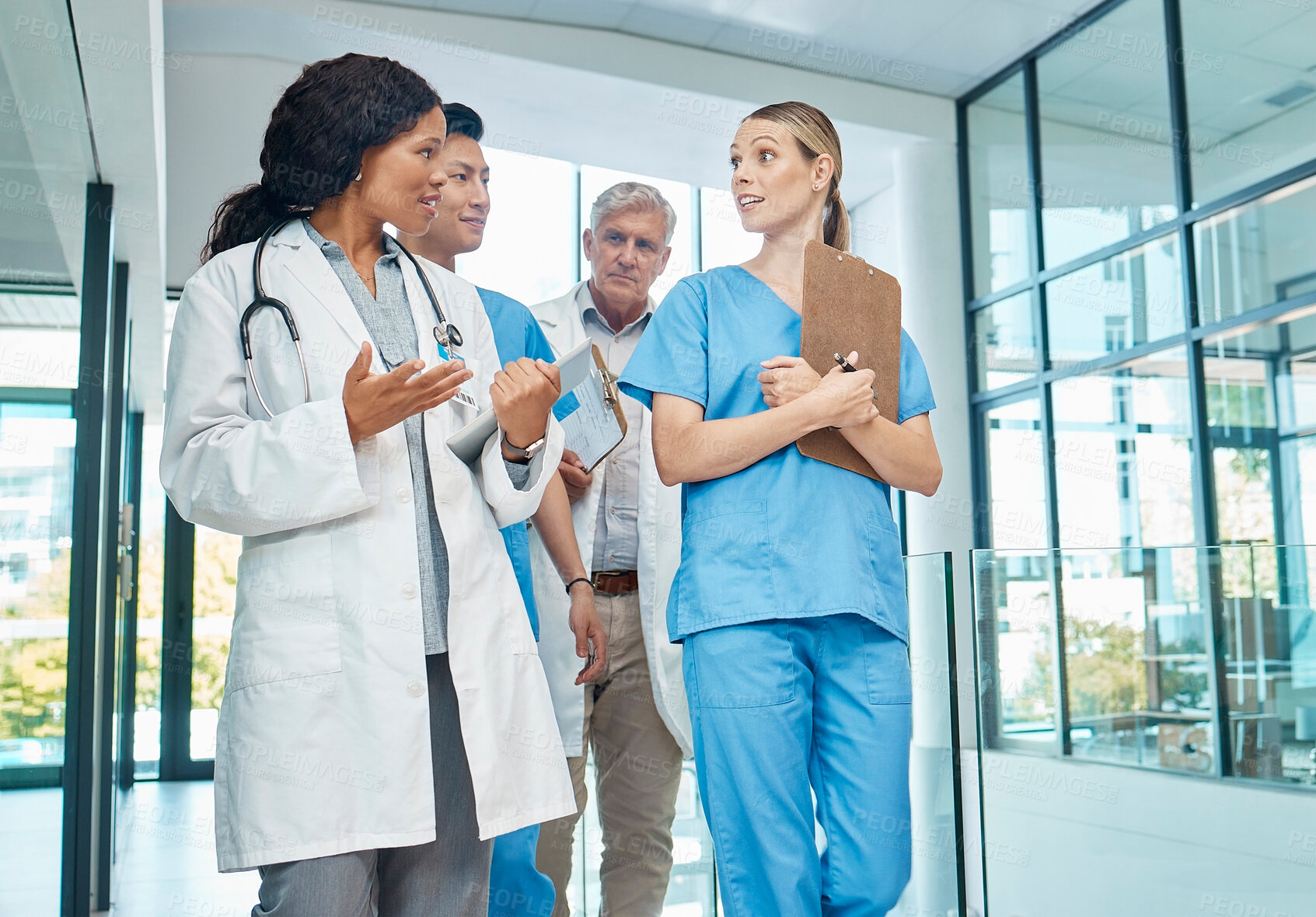 Buy stock photo Walking, doctors and nurses talking in a hospital for planning, strategy or results. Diversity men and women healthcare group together for discussion, virus or surgery with professional medical team