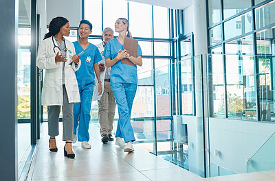 Buy stock photo Healthcare, doctors and nurses walking together for discussion, planning or schedule. Diversity, men or women medical group talking about support strategy, medicine and surgery teamwork in hospital