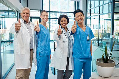 Buy stock photo Healthcare, doctors and medical group thumbs up in a hospital for teamwork, support and trust. Portrait of diversity men and women team hands for collaboration, health insurance and professional care