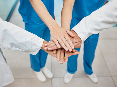 Buy stock photo Shot of a group of unrecognizable doctors stacking their hands at a hospital