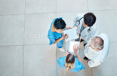 Buy stock photo Healthcare, doctors and group meeting with a tablet for discussion, planning or research. Above men and women medical staff talking about team collaboration, online schedule or surgery in a hospital
