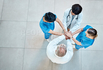 Buy stock photo Healthcare, doctors and team with hands together in a hospital for support, trust and teamwork. Above men and women medical group or staff stacked for goal motivation, collaboration and solidarity