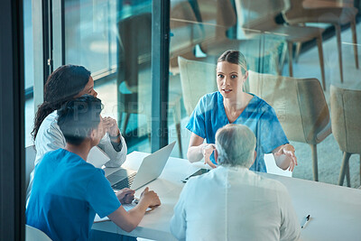 Buy stock photo Medical team, doctors and meeting with a laptop for a discussion, planning or research at table. Men and women healthcare group talking about communication strategy, virus or surgery in a hospital