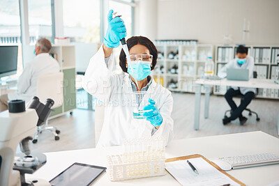 Buy stock photo Shot of a young scientist using a dropper and beaker in a lab