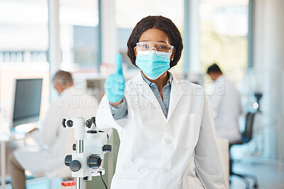 Buy stock photo Portrait of a young scientist showing thumbs up in a lab