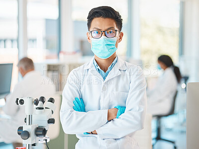 Buy stock photo Portrait of a young scientist standing with his arms crossed in a lab