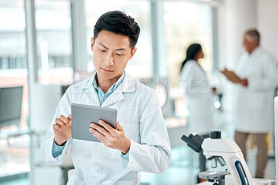 Buy stock photo Science research, reading and a man with a tablet for information, analytics and physics. Serious, medical and a male scientist with technology for an email, chemistry education and analysis