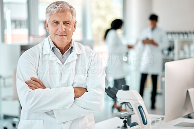 Buy stock photo Portrait of a senior scientist standing with his arms crossed in a lab