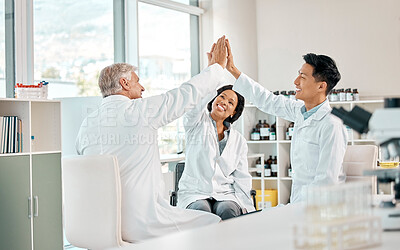 Buy stock photo Shot of a group of scientists giving each other a high five in a lab