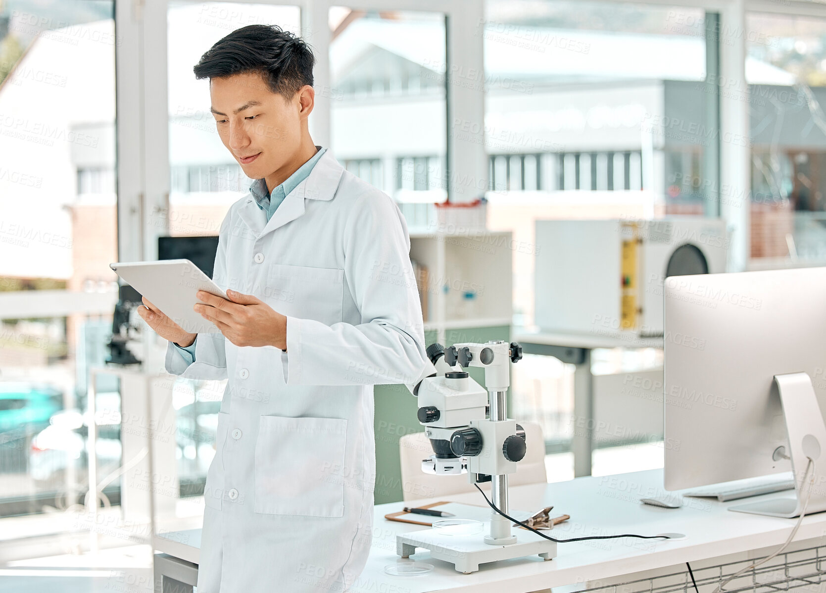 Buy stock photo Science, Asian man and online with tablet in laboratory for monitor experiment, scientific analysis and medical research for study. Tech, internet and digital for trial results, breakthrough and cure