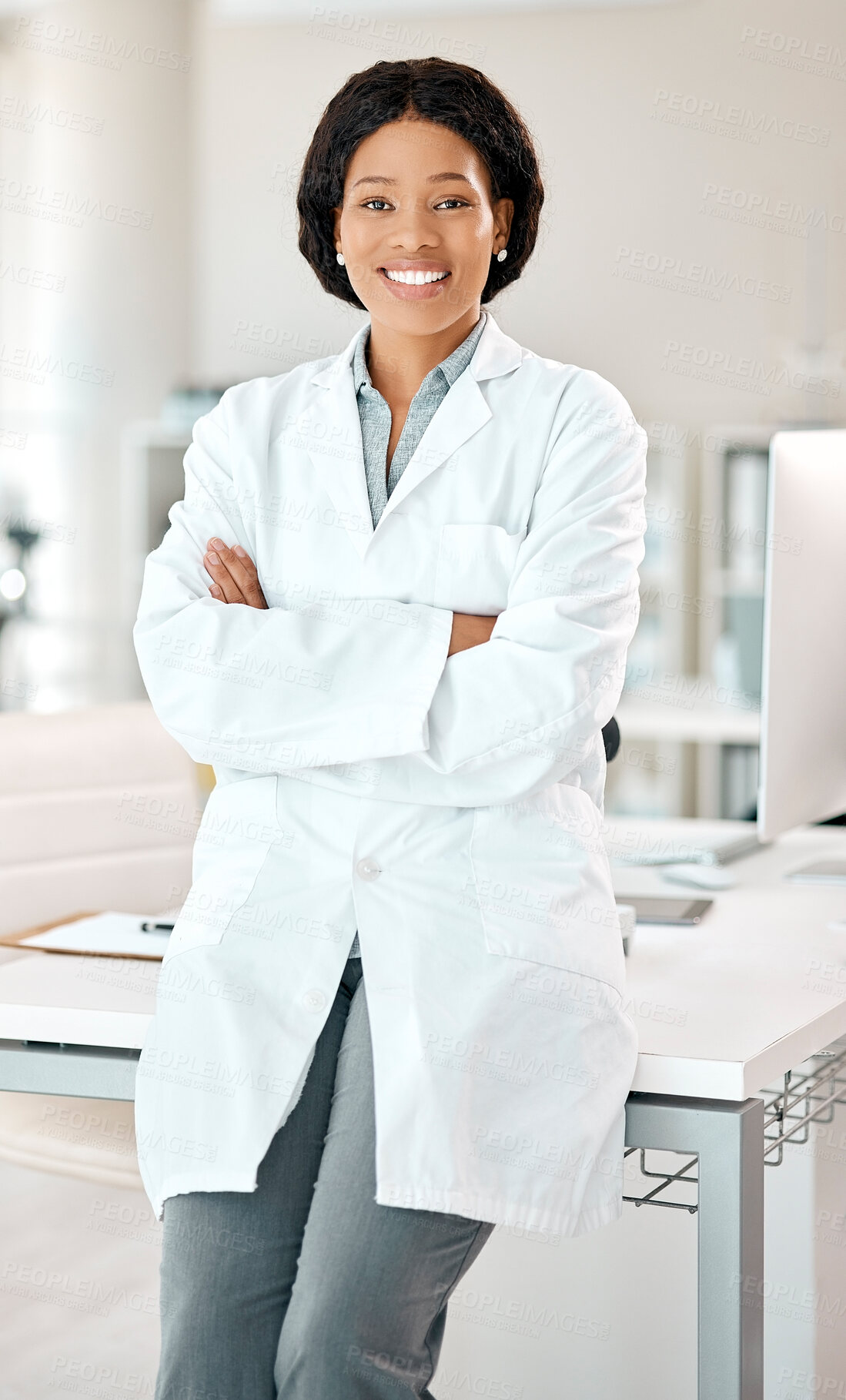 Buy stock photo Portrait of a young scientist standing with her arms crossed in a lab