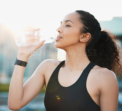 Buy stock photo Outdoor, woman and drinking water for fitness or hydration on morning run, exercise and workout in New York. Female person, sportswear and lens flare on training for wellness, wellbeing and self care