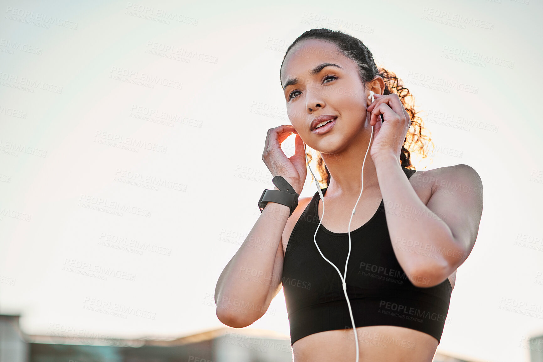 Buy stock photo Outdoor, woman and smile with earphones for fitness on break with exercise, running and workout in Atlanta. Mockup space, sky and happy with music, audio or podcast for health, wellness and self care