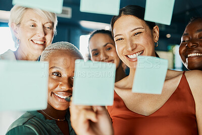 Buy stock photo Cropped shot of an attractive and diverse group of businesswomen working with sticky notes on a glass wipe board in the boardroom