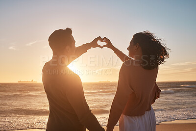 Buy stock photo Biracial couple holding their hands together in a heart shape at the beach