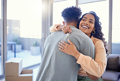 Buy stock photo Happy couple, hug and real estate with key for new home, moving in or mortgage loan together indoors. Woman hugging man with smile in happiness, property or investment with keys to apartment building