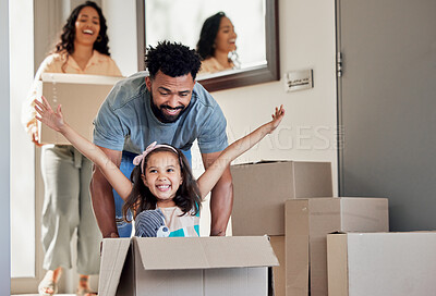 Buy stock photo Happy family, real estate and moving in new home playing with box for property, mortgage loan or celebration. Mother, father and little girl enjoying play time with boxes for fun bonding in the house