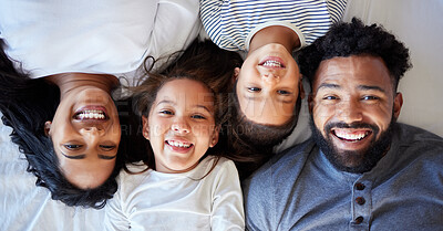 Buy stock photo Happy family, portrait and relax with children above on floor for bonding, weekend or holiday at home. Top view of mother, father and kids lying with smile in joy for love, care or comfort at house