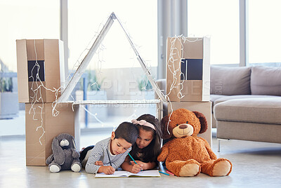 Buy stock photo Shot of two little siblings drawing together at home