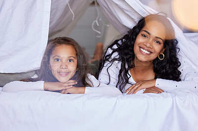 Buy stock photo Shot of a young mother and daughter relaxing together at home