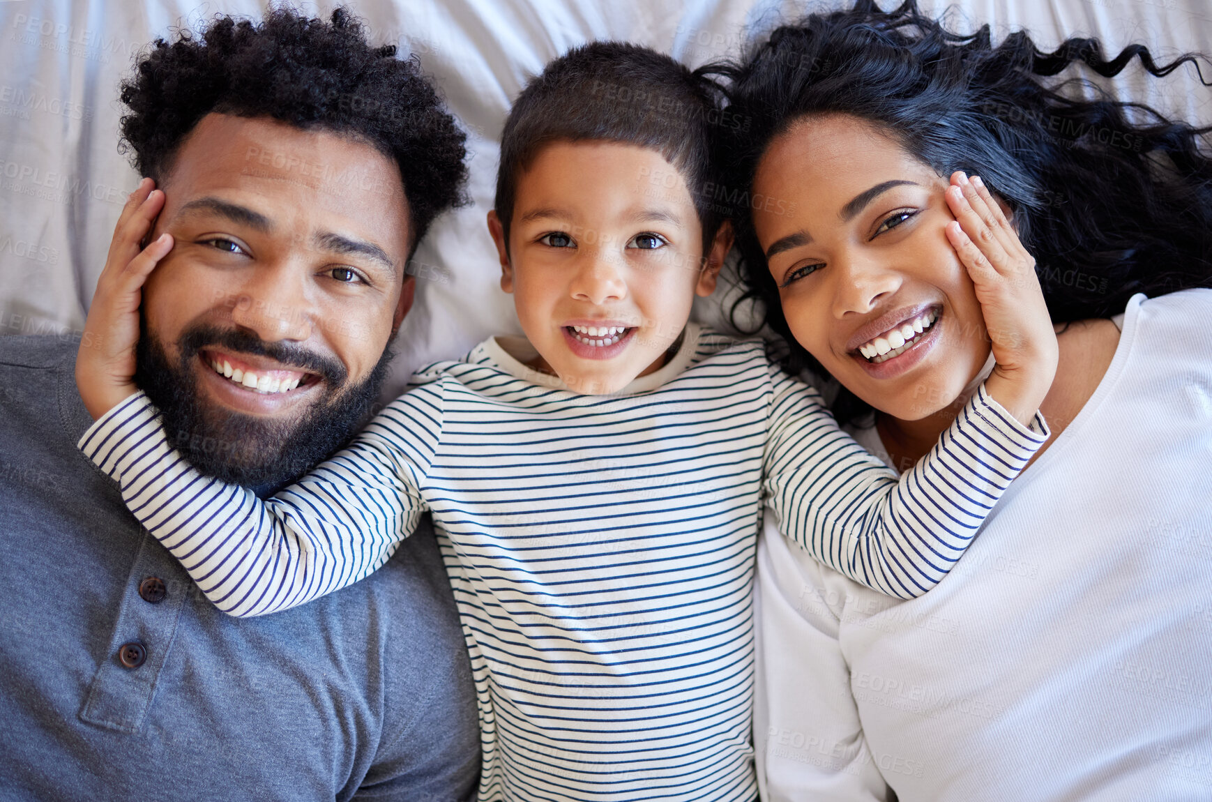 Buy stock photo Above family, boy and happy portrait on bed for morning peace, bonding time and relationship trust in home. Parents, young child and smile together on mattress for wake up, relax and love support