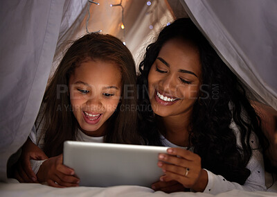 Buy stock photo Shot of a young mother and daughter using a digital tablet together at home