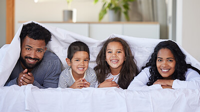 Buy stock photo Family, children and happy portrait with blanket for support, healthy relationship and security or love in home bedroom. Smile, parents and kids on mattress with cover, bonding time and relax in bed