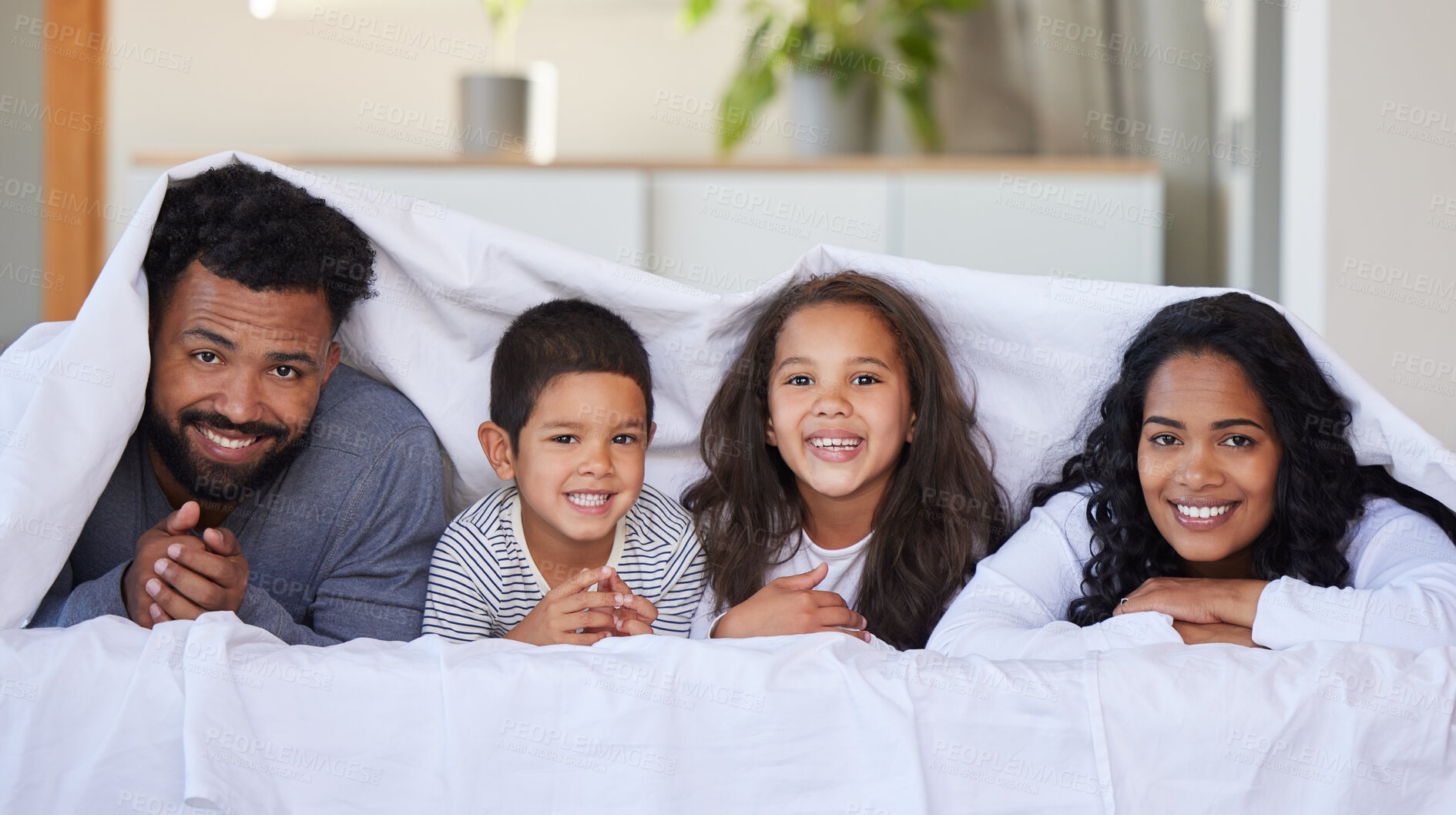 Buy stock photo Family, children and happy portrait with blanket for support, healthy relationship and security or love in home bedroom. Smile, parents and kids on mattress with cover, bonding time and relax in bed