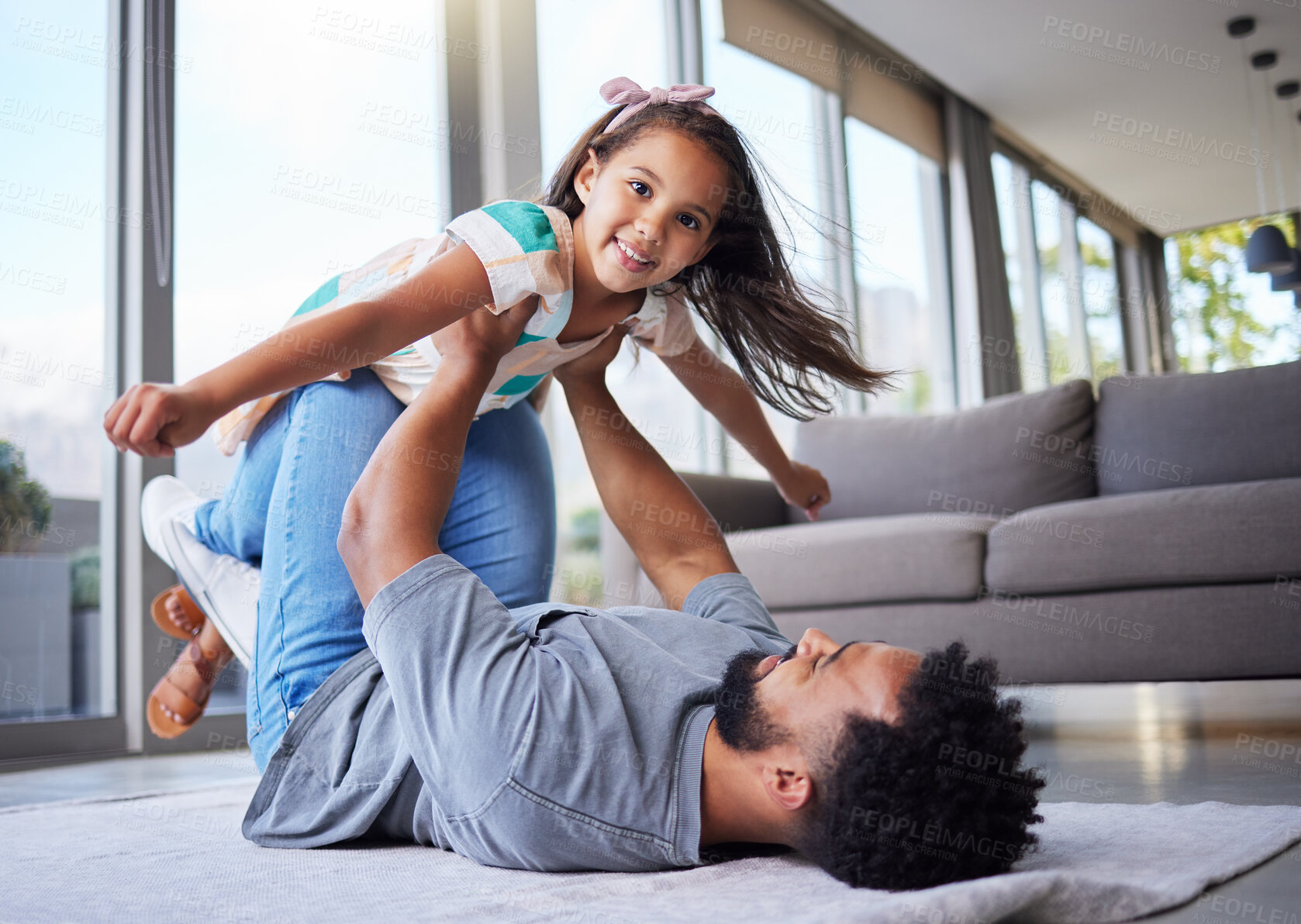 Buy stock photo Happy father, playing and flying with daughter for bonding or holiday weekend in living room at home. Dad holding or lifting little girl, child or kid in air for love or support on floor at house