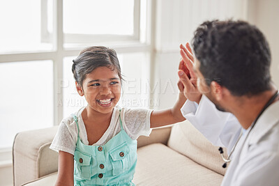 Young doctor celebrating good news with his patient. Smiling girl high fives her doctor after learning of positive test results