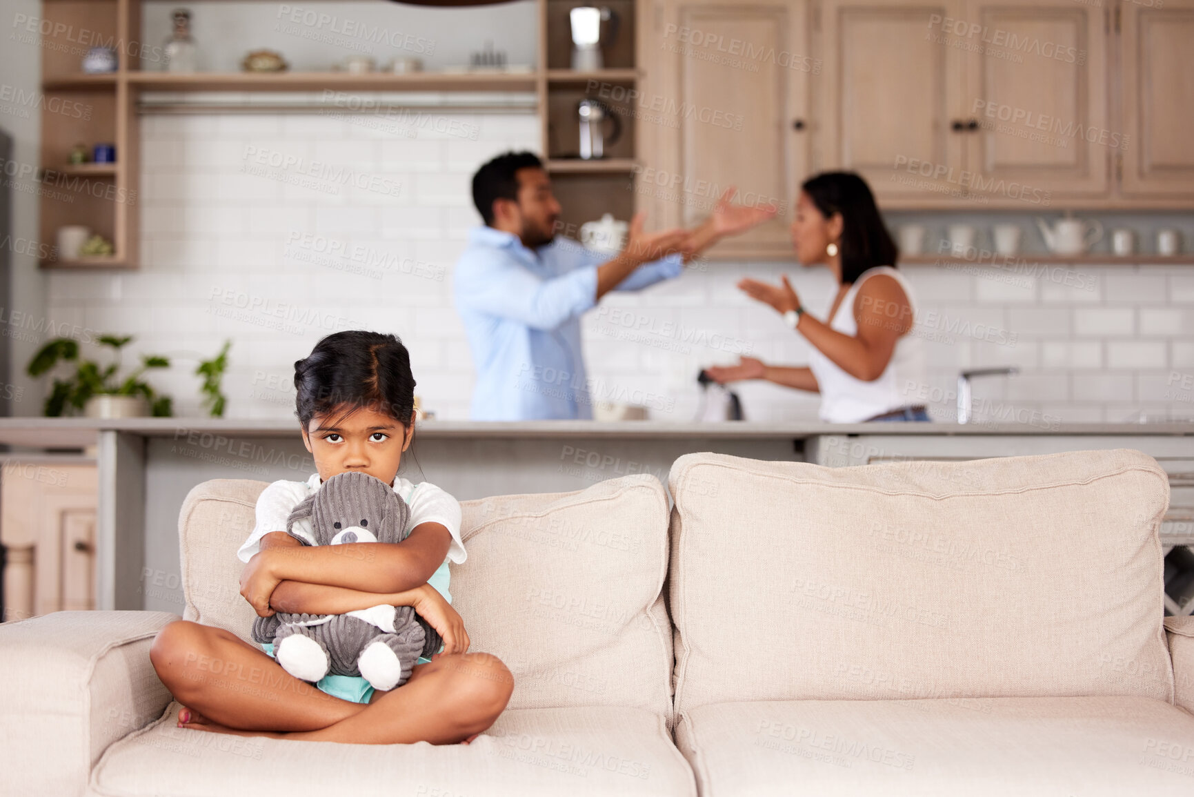 Buy stock photo Afraid little girl holding a teddy in an abusive household. Young couple fighting while their child sits on the couch