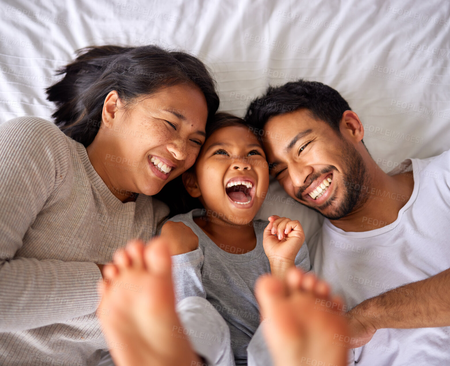 Buy stock photo Bed, fun and happy family playing, wake up and happy from above, tickle and laughing in their home. Bedroom, games and girl with parents, smile and laugh, relax and love in their house on the weekend