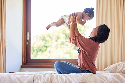 Buy stock photo Mother playing baby daughter bed room carrying lifting fun bonding