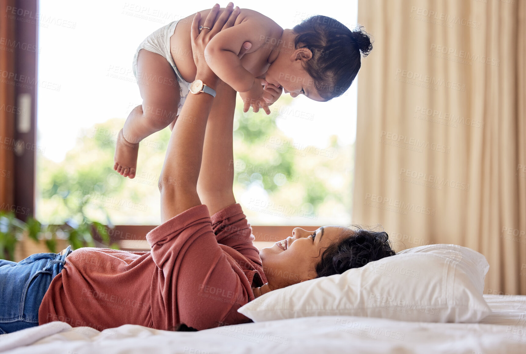 Buy stock photo Mom, baby and playing on bed in house for love, development and bonding together with trust. Mother,  toddler and fun game in apartment bedroom for growth, wellness and care with support or lifting