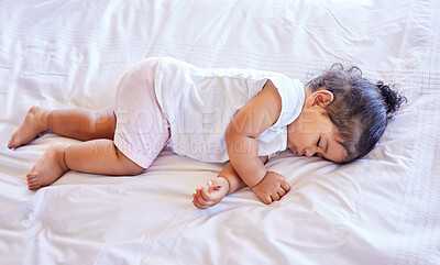Buy stock photo Little baby girl sleeping on her bed. Toddler sleeping in her nursery. Hispanic baby sleeping and dreaming. Baby resting and sleeping alone at home. Young, calm infant lying on her bed sleeping