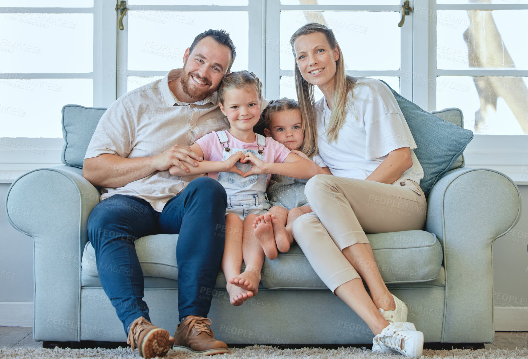 Buy stock photo Shot of a young family relaxing together at home