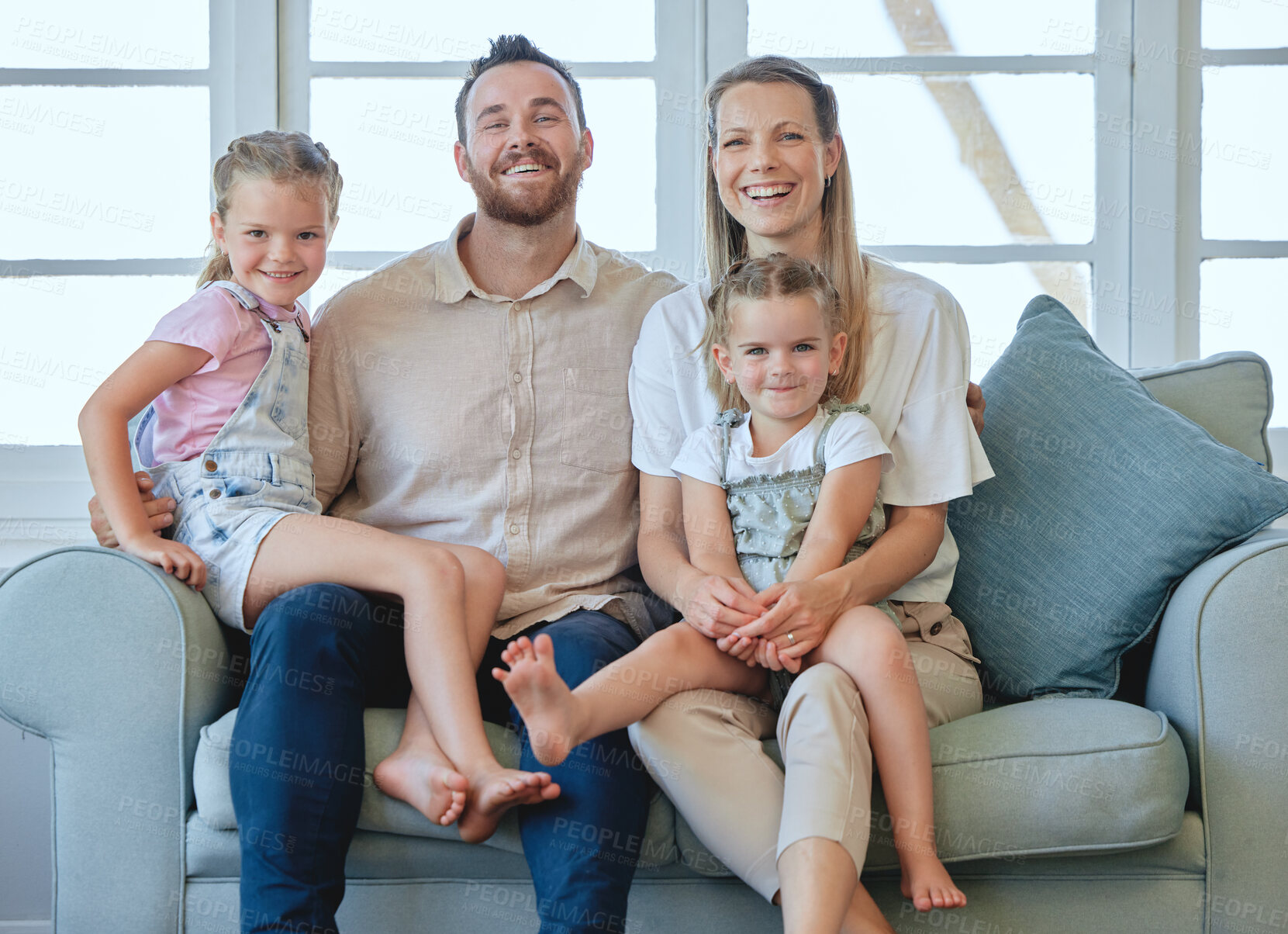 Buy stock photo Shot of a young family relaxing together at home