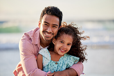 Buy stock photo Shot of a man spending the day at the beach with his adorable daughter